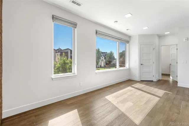 a living room with furniture and wall paintings