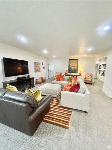 838 East Mountain Road North Ogden, UT 84414 - Photo 29 of 37 Spacious entertainment area featuring recessed lighting, light-colored walls, and a large flat-screen television