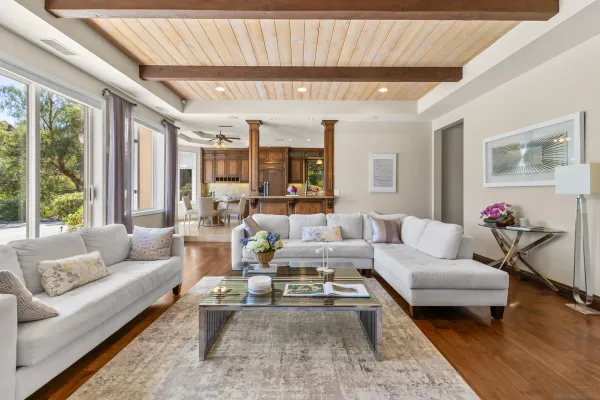 a dining room with furniture a chandelier and wooden floor