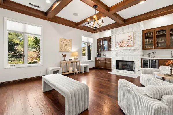 a living room with furniture a flat screen tv and a large window