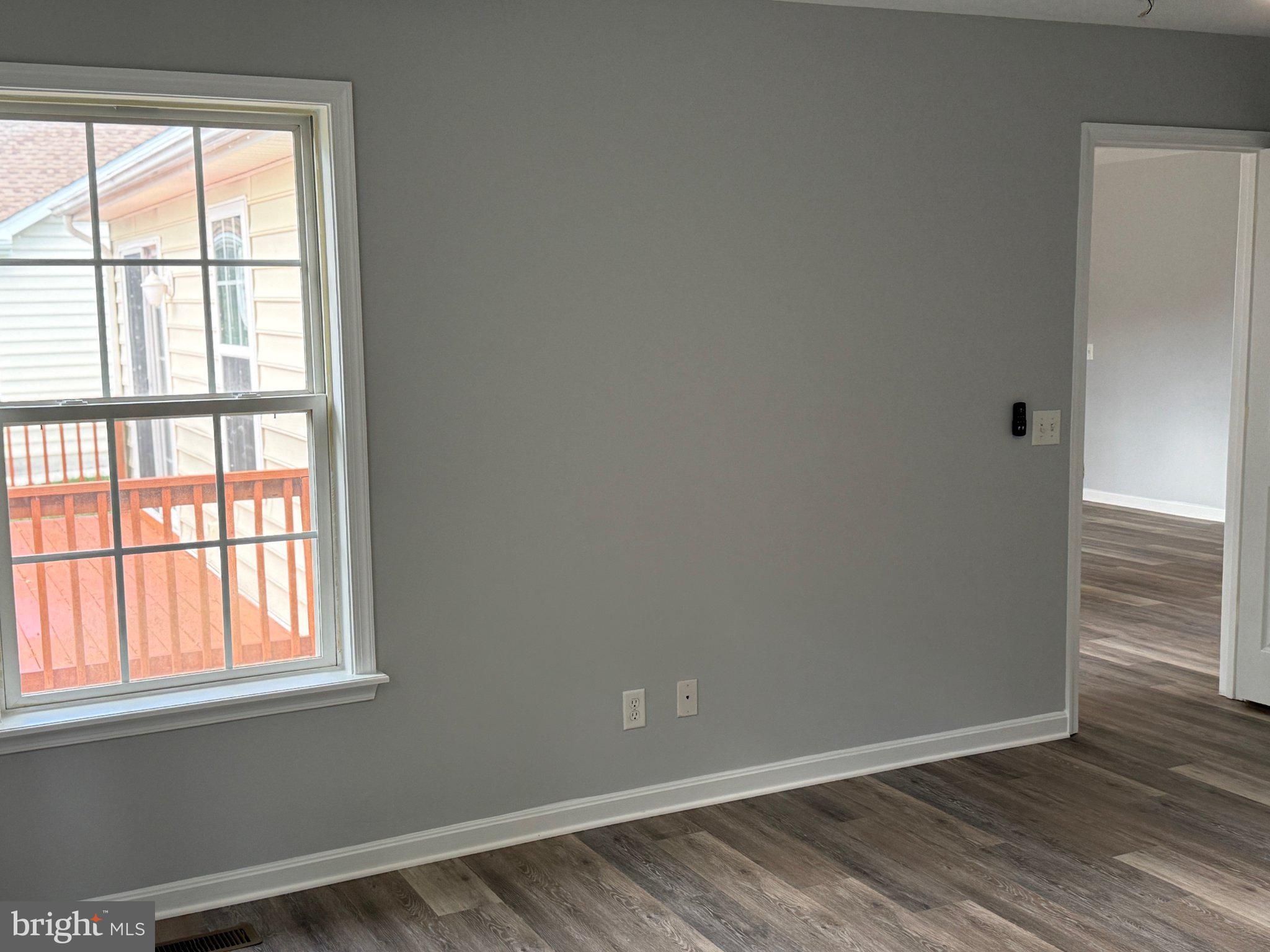 30952 Sandy Ridge Drive Lewes, DE 19958 - Photo 10 of 17 an empty room with wooden floor and windows