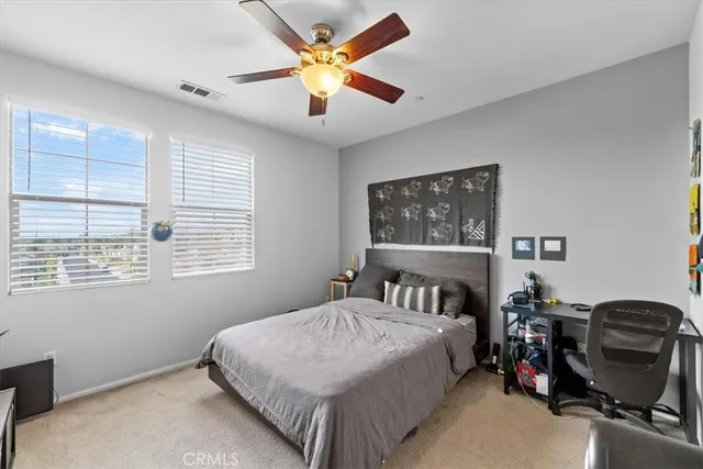 a bedroom with a bed a dresser and chair