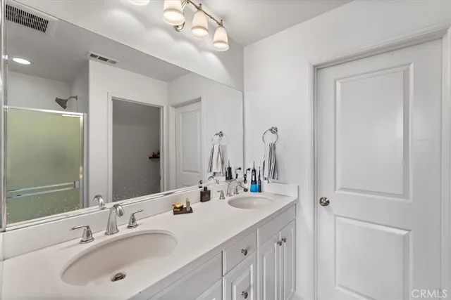 a bathroom with a sink vanity and a mirror
