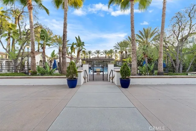 a view of a street with potted plants