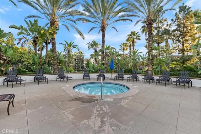 a swimming pool with outdoor seating and a patio