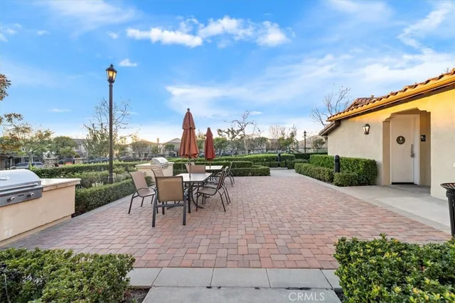 a view of a patio with a table and chairs