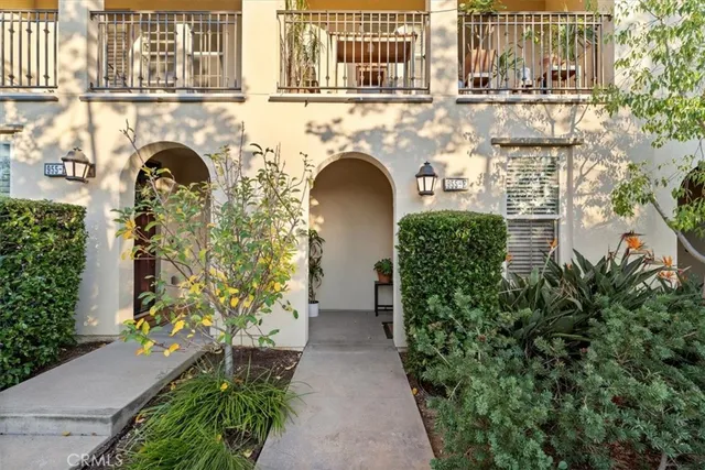 a front view of a house with plants and garden