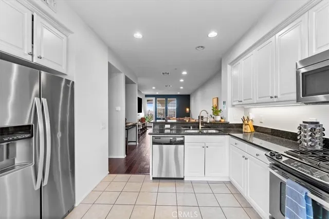 a kitchen with a sink a refrigerator and cabinets