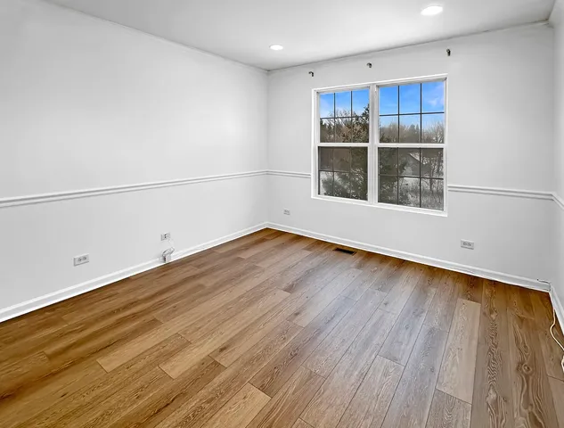 a view of a room with wooden floor and window