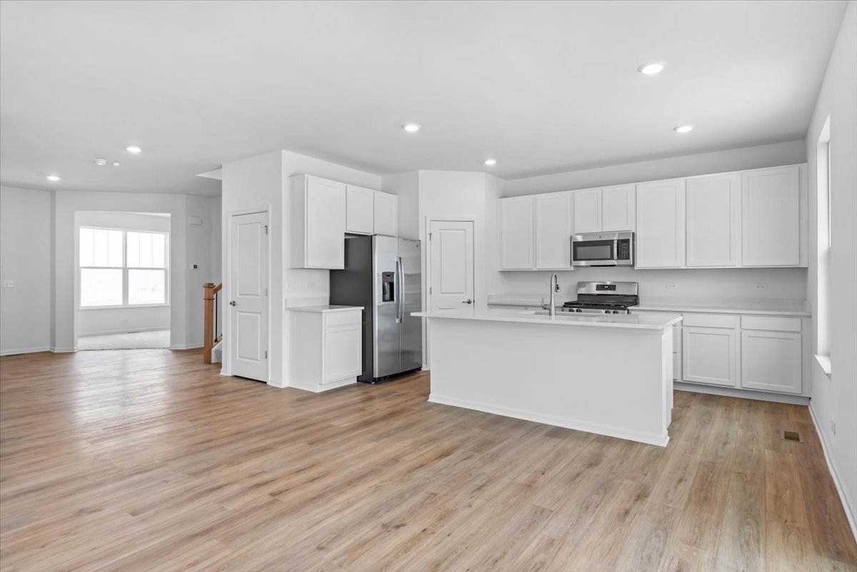 81 Sweetflag Circle Elgin, IL 60124 - Photo 17 of 51 a kitchen with stainless steel appliances a refrigerator sink and cabinets