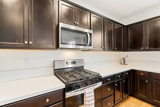 a large white kitchen with a sink and a large window