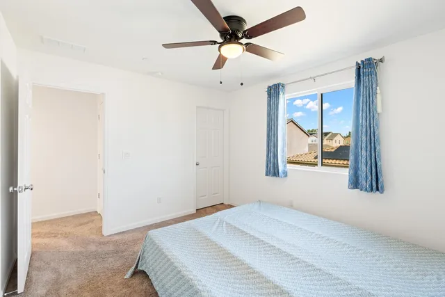 a bedroom with a bed dresser and a window