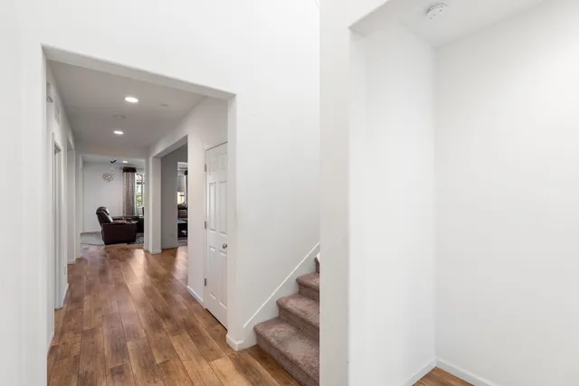 a view of entryway and hall with wooden floor