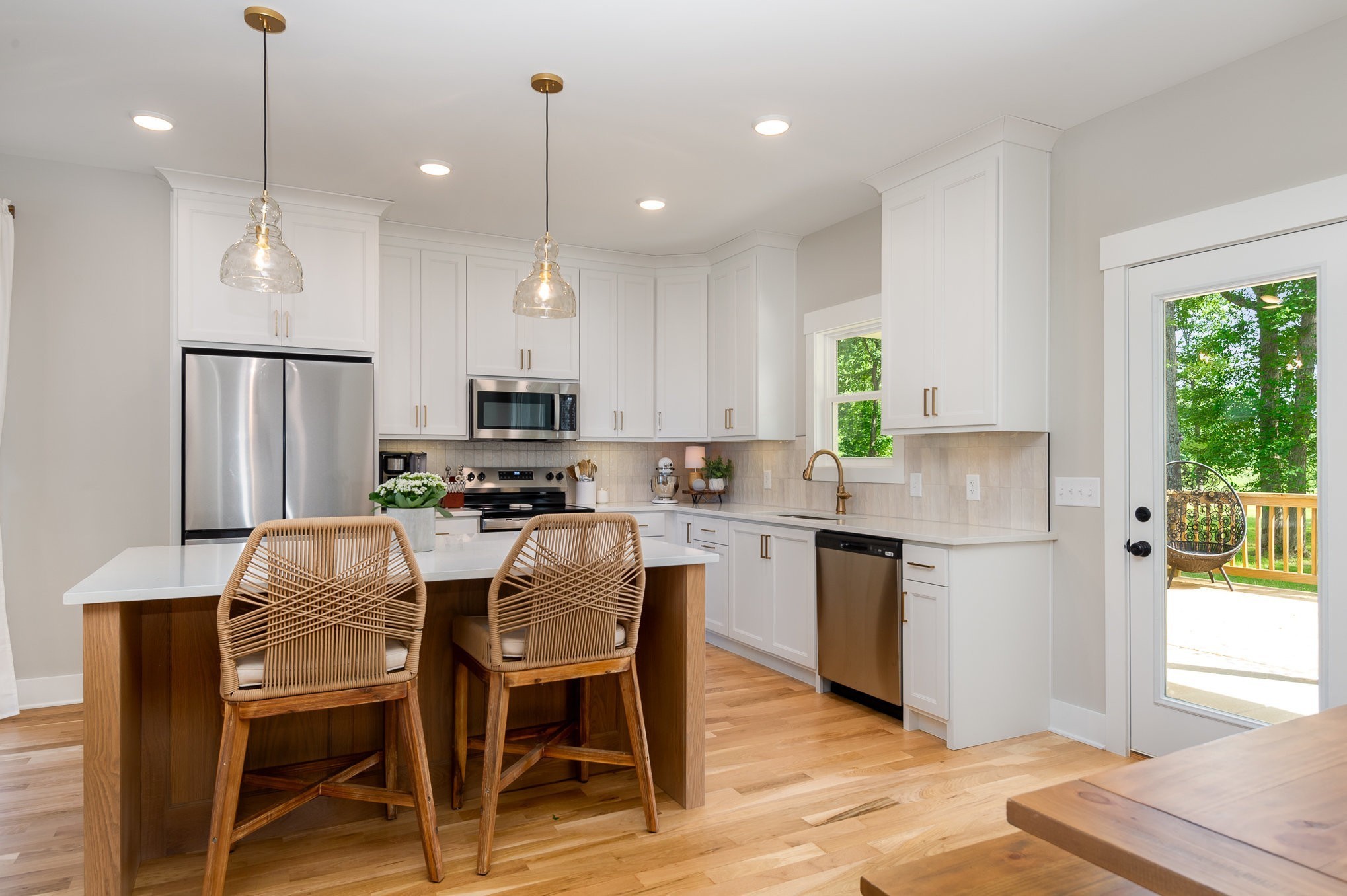 4345 South Garrett Road Springfield, TN 37172 - Photo 11 of 30 a kitchen with kitchen island granite countertop a table chairs refrigerator and microwave