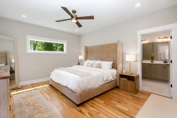 a bedroom with a bed and a view of kitchen