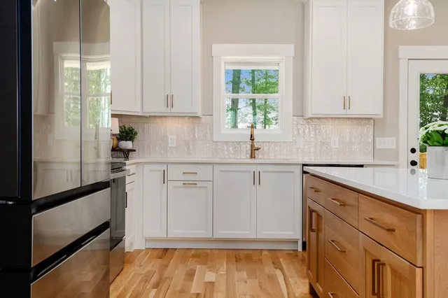 a kitchen with a sink cabinets and window