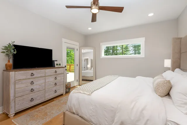 a bedroom with a large bed and a flat screen tv