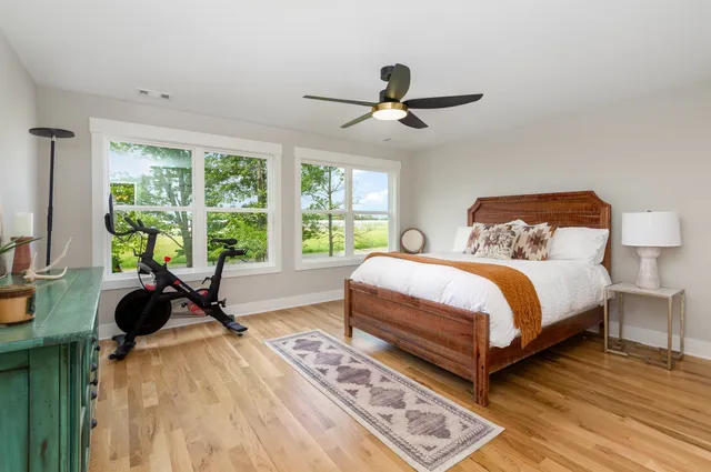 a bedroom with a bed and a large window