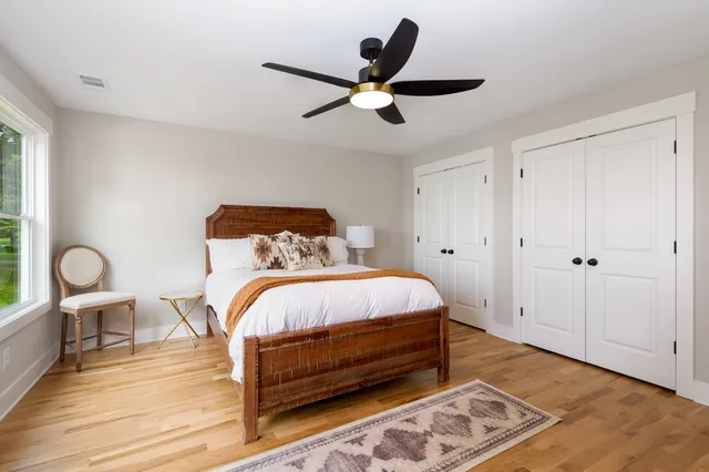 a bedroom with a bed and a chandelier