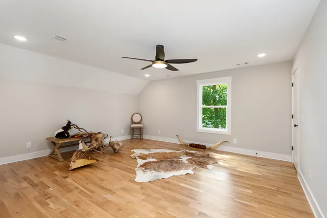 a living room with a bed furniture and a window