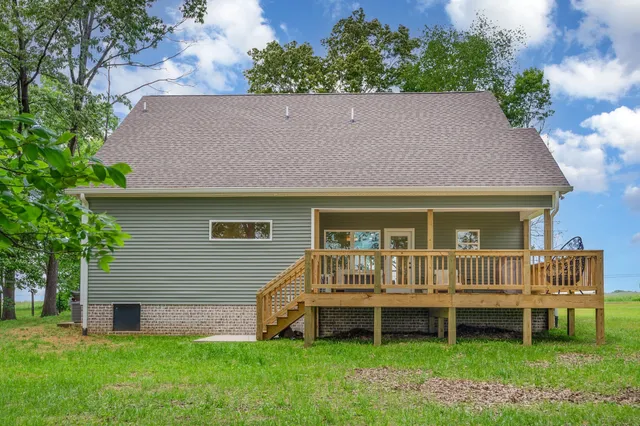 a front view of a house with a garden and deck