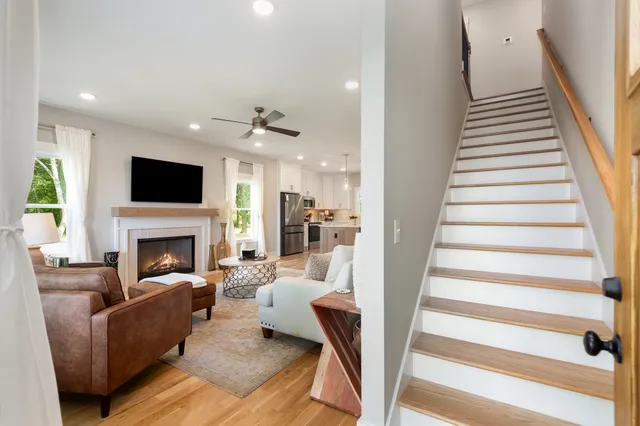 a living room with furniture a fireplace and a flat screen tv
