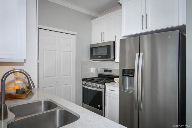 a kitchen with a refrigerator stove and sink