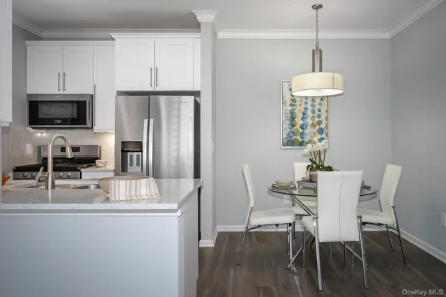 a view of a dining room with furniture wooden floor and chandelier