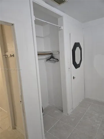 a bathroom with a granite countertop shower and a sink