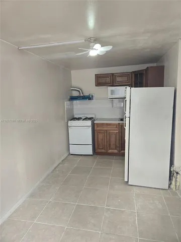 a kitchen with a cabinets and white stainless steel appliances