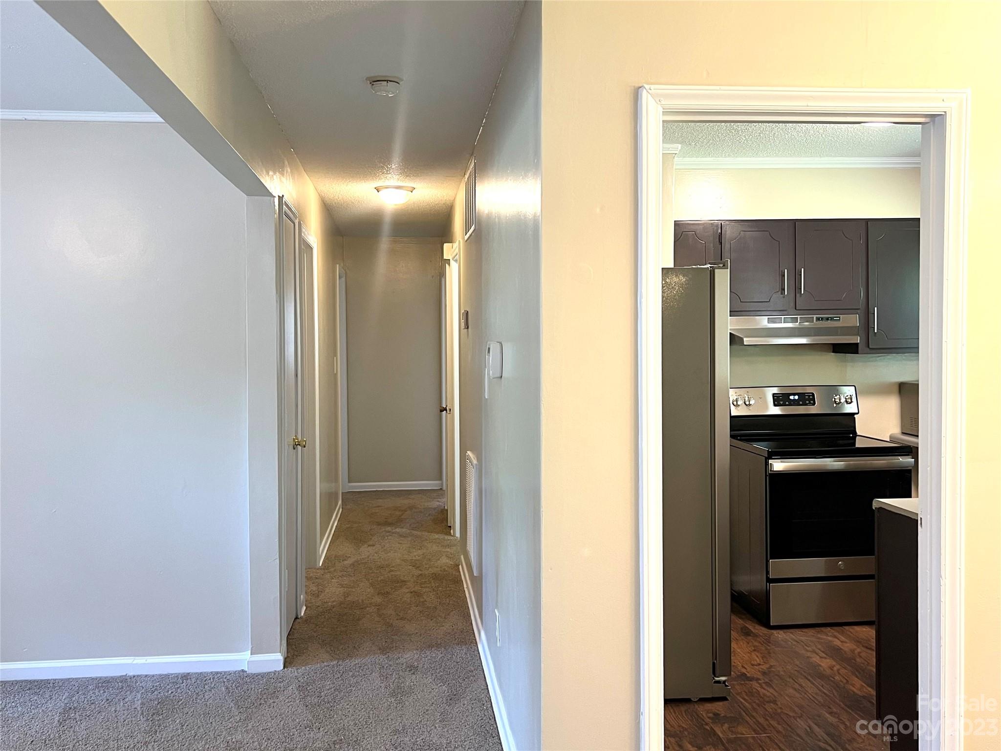 911 Taylor Street Wingate, NC 28174 - Photo 11 of 12 a view of a kitchen from the hallway