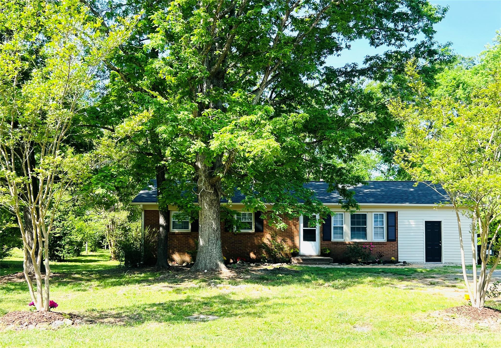 911 Taylor Street Wingate, NC 28174 - Photo 2 of 12 a view of a house with yard in front of house