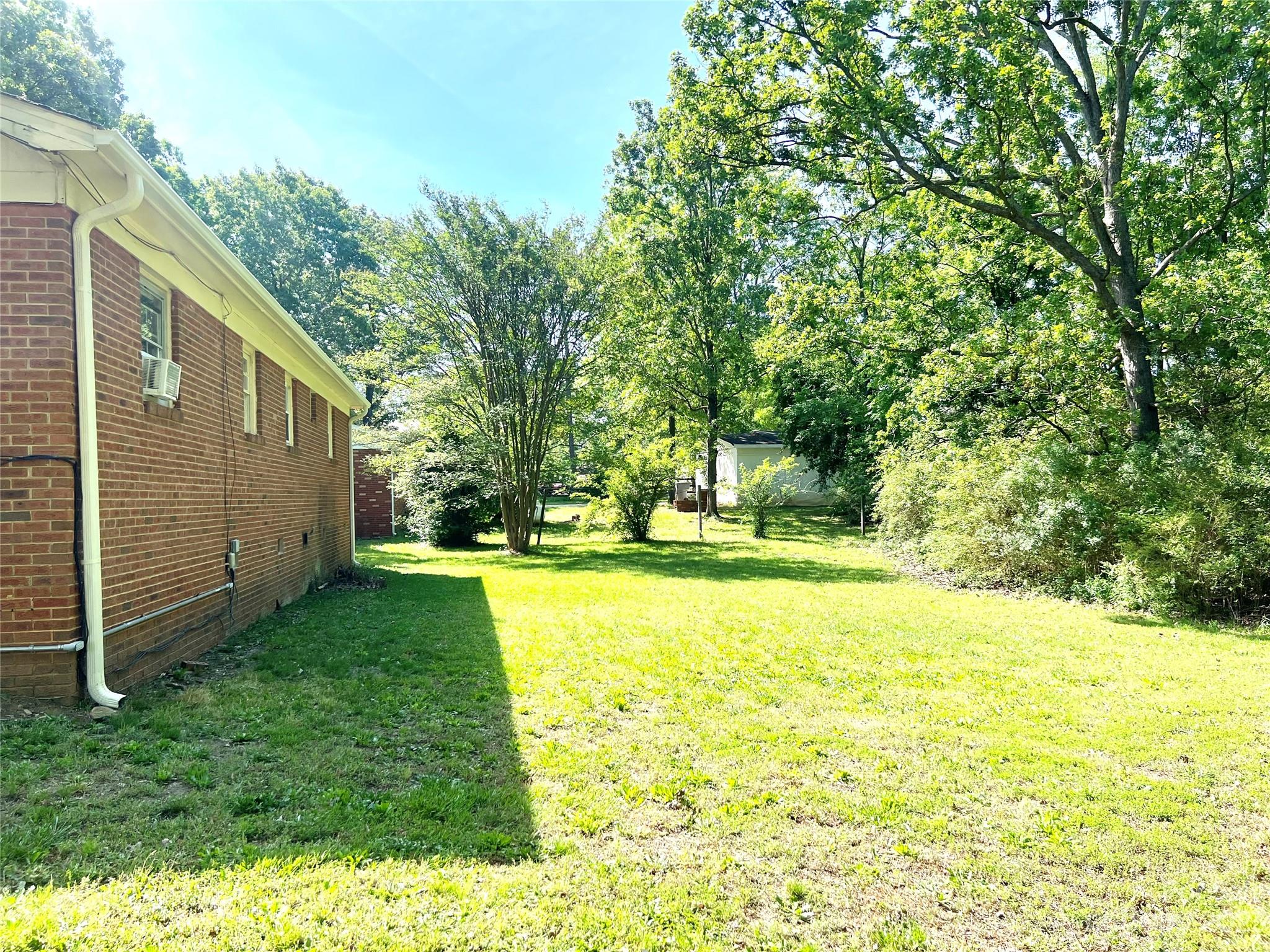 911 Taylor Street Wingate, NC 28174 - Photo 6 of 12 a view of back yard of the house with a swimming pool