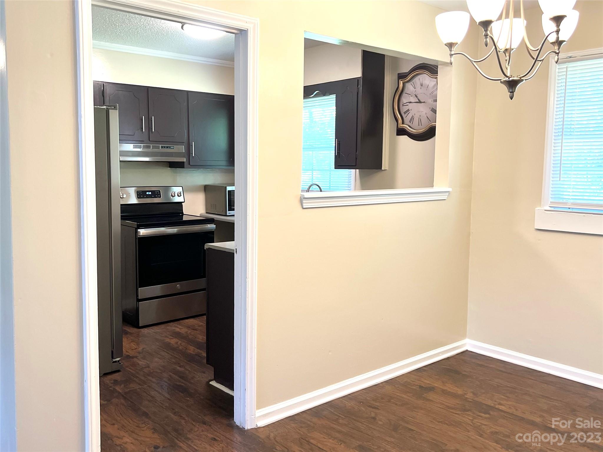 911 Taylor Street Wingate, NC 28174 - Photo 10 of 12 a view of a hallway with wooden floor