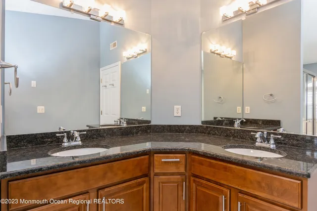 a bathroom with a sink double vanity and a mirror
