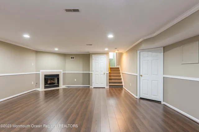 a view of a room with wooden floor and fireplace