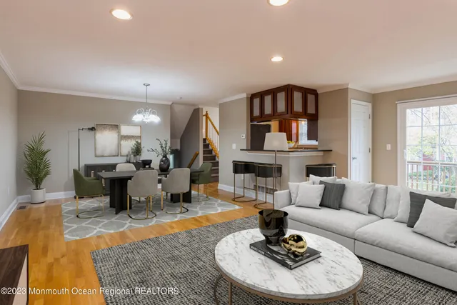a living room with fireplace furniture and a rug