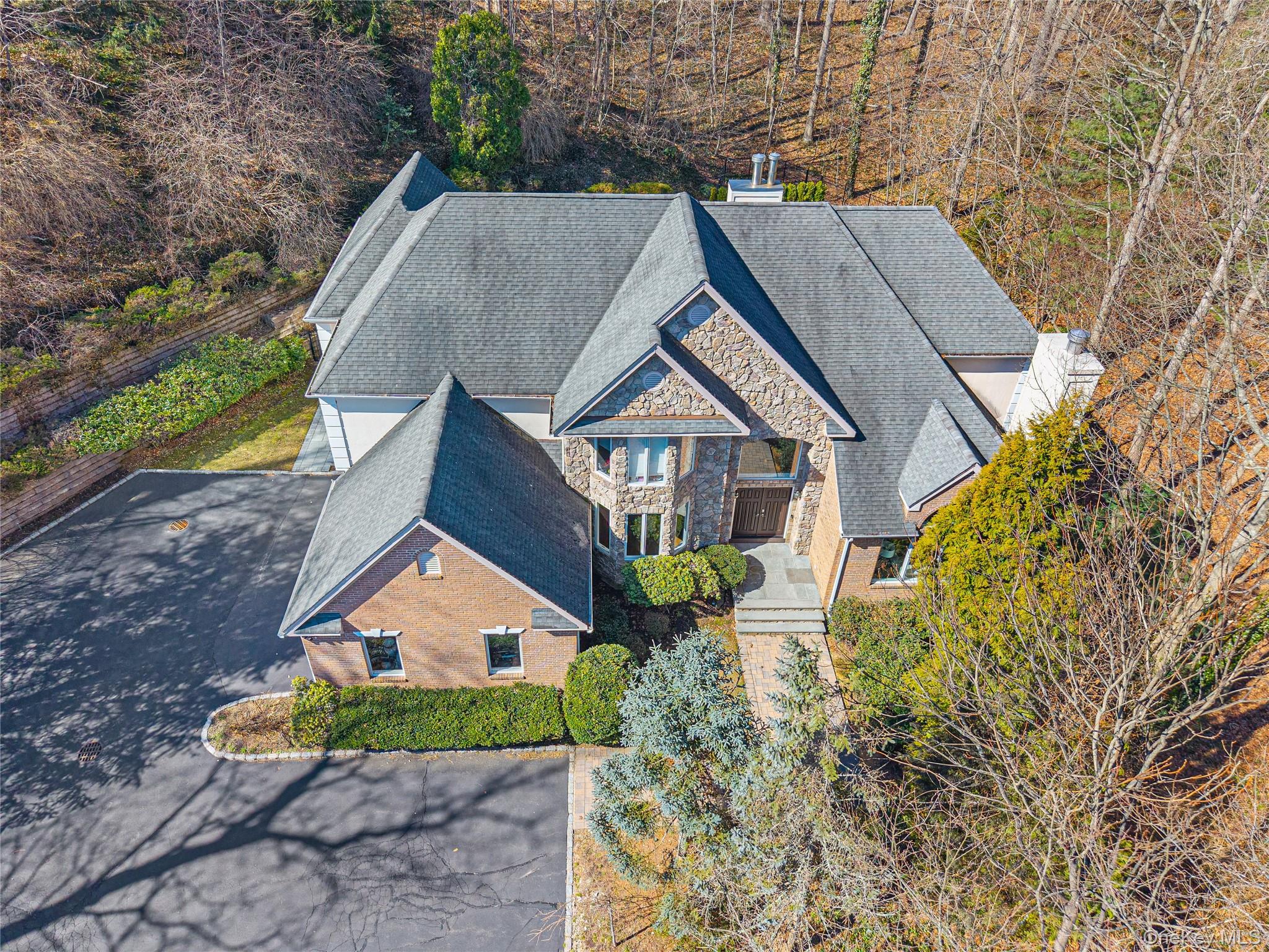 a aerial view of a house next to a yard
