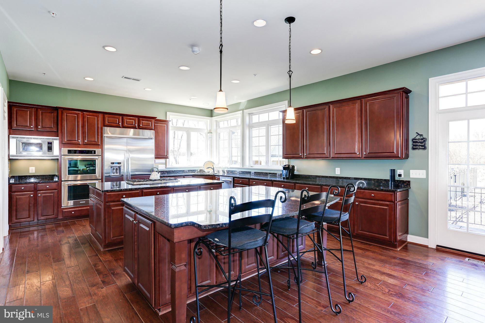 15520 Mount Nebo Road Poolesville, MD 20837 - Photo 12 of 30 a kitchen with stainless steel appliances granite countertop wooden cabinets a stove a sink and a center island