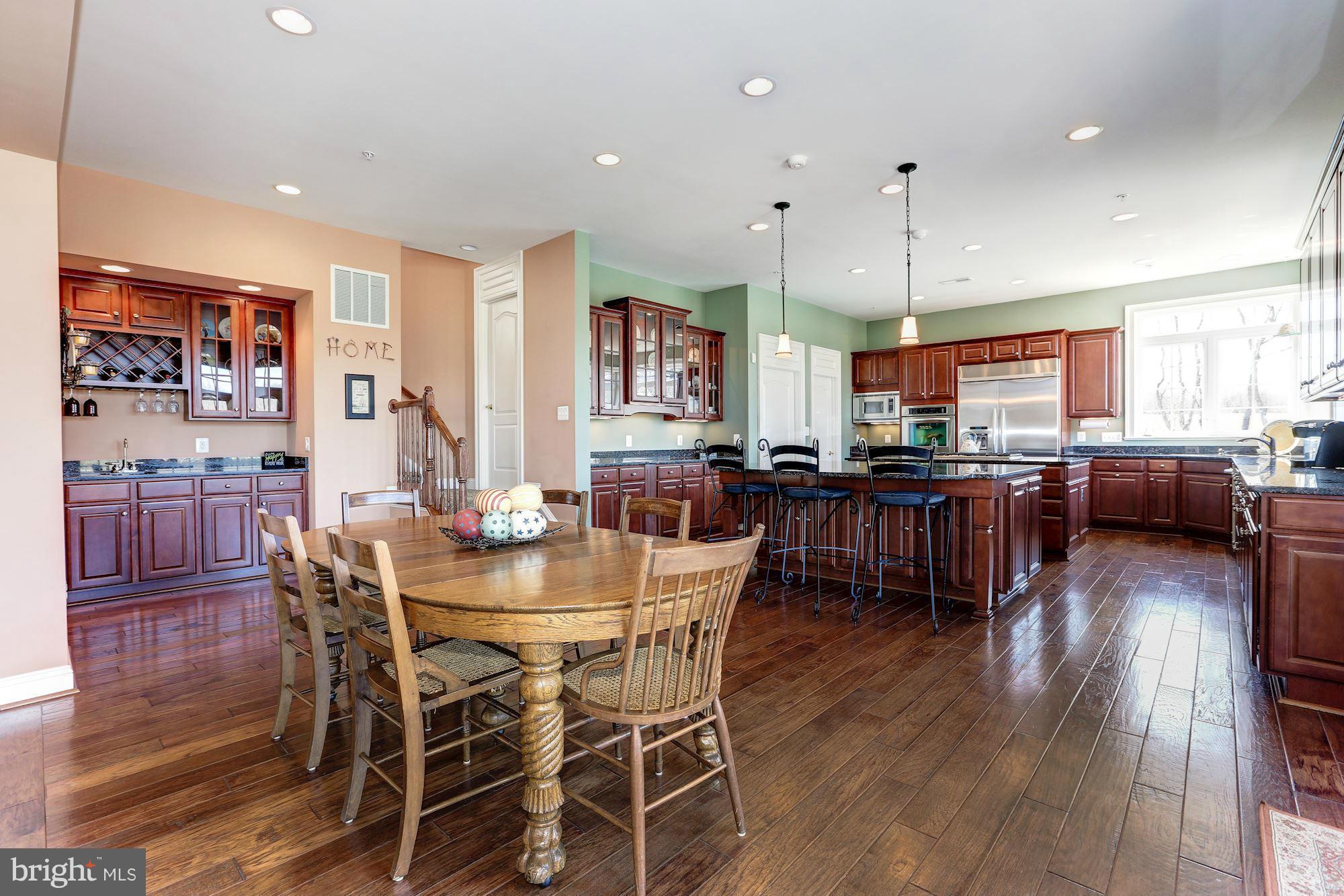 15520 Mount Nebo Road Poolesville, MD 20837 - Photo 13 of 30 a view of a dining area with furniture and wooden floor