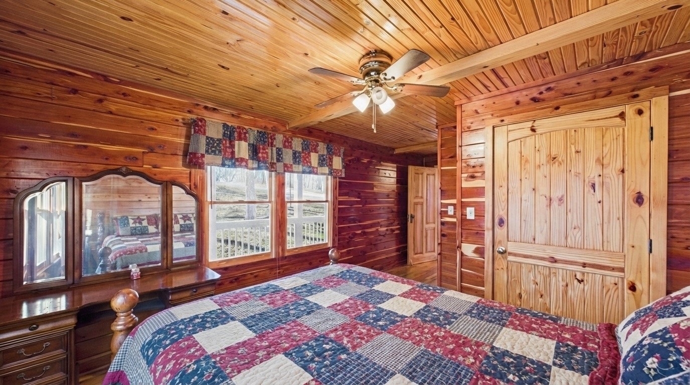 22 Roberts Lane Cadiz, KY 42211 - Photo 15 of 84 a bedroom with a large bed and a chandelier