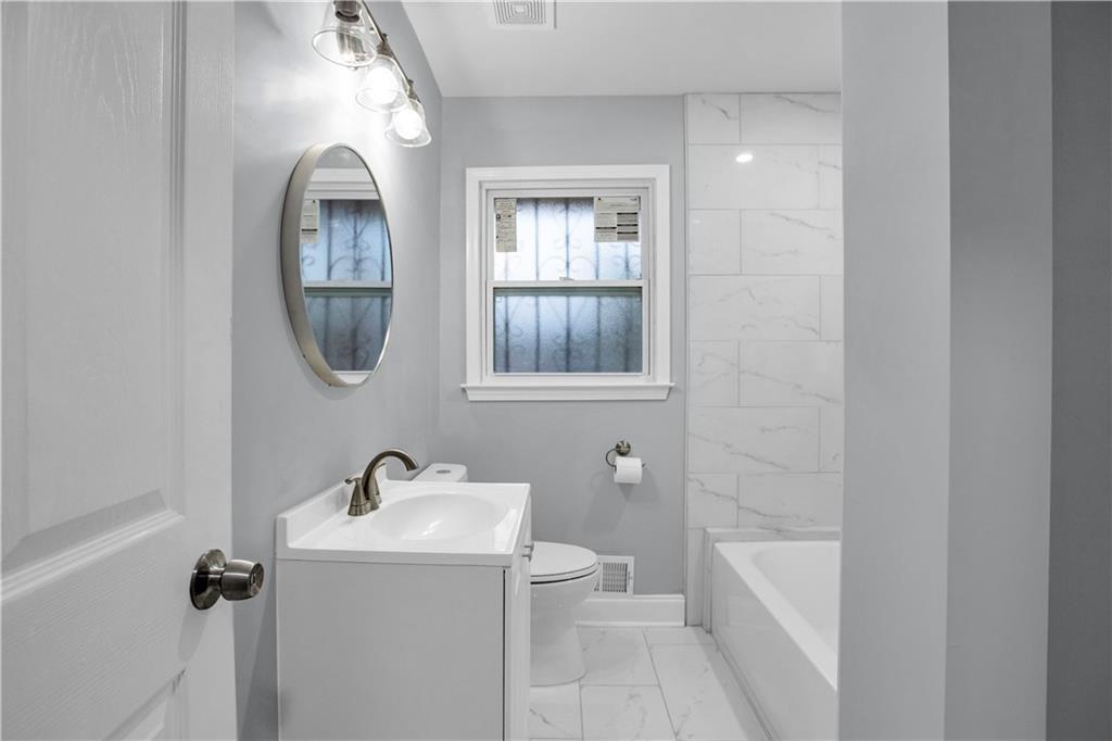 2000 Fairburn Road Southwest Atlanta, GA 30331 - Photo 12 of 24 a bathroom with a sink a toilet and shower