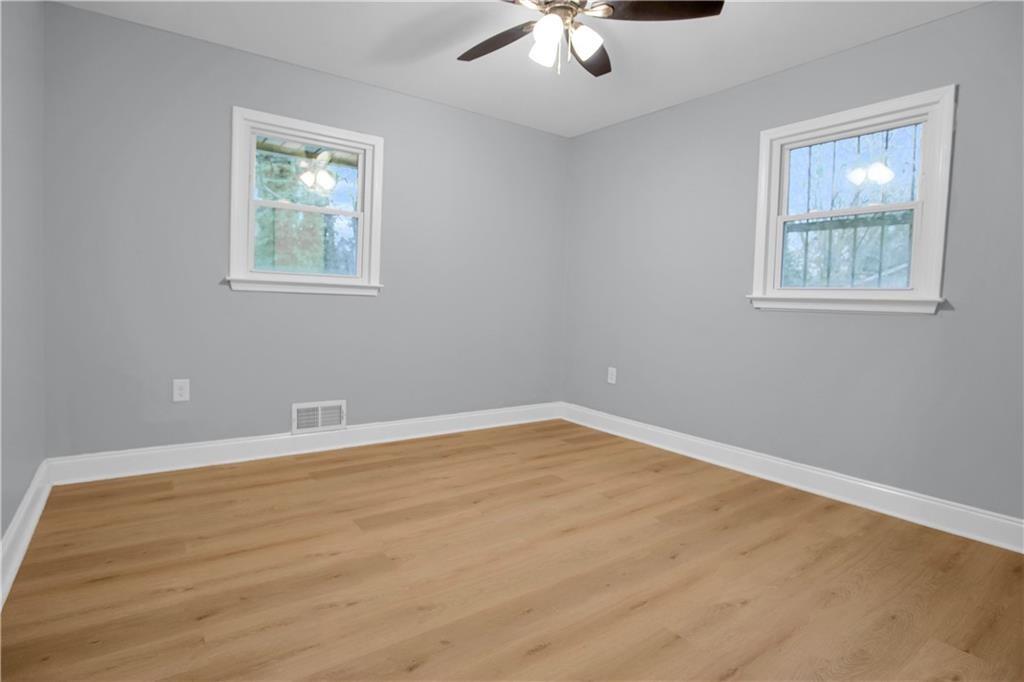 2000 Fairburn Road Southwest Atlanta, GA 30331 - Photo 17 of 24 a view of an empty room with a window and wooden floor