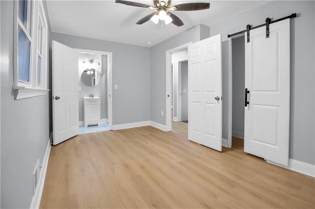 2000 Fairburn Road Southwest Atlanta, GA 30331 - Photo 18 of 24 a view of a livingroom with a ceiling fan walk in closet and a bathroom
