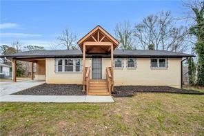 2000 Fairburn Road Southwest Atlanta, GA 30331 - Photo 3 of 24 a front view of a house with a yard