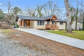 2000 Fairburn Road Southwest Atlanta, GA 30331 - Photo 4 of 24 a front view of a house with a yard and garage
