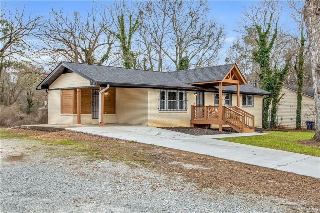 2000 Fairburn Road Southwest Atlanta, GA 30331 - Photo 5 of 24 a front view of a house with a garden