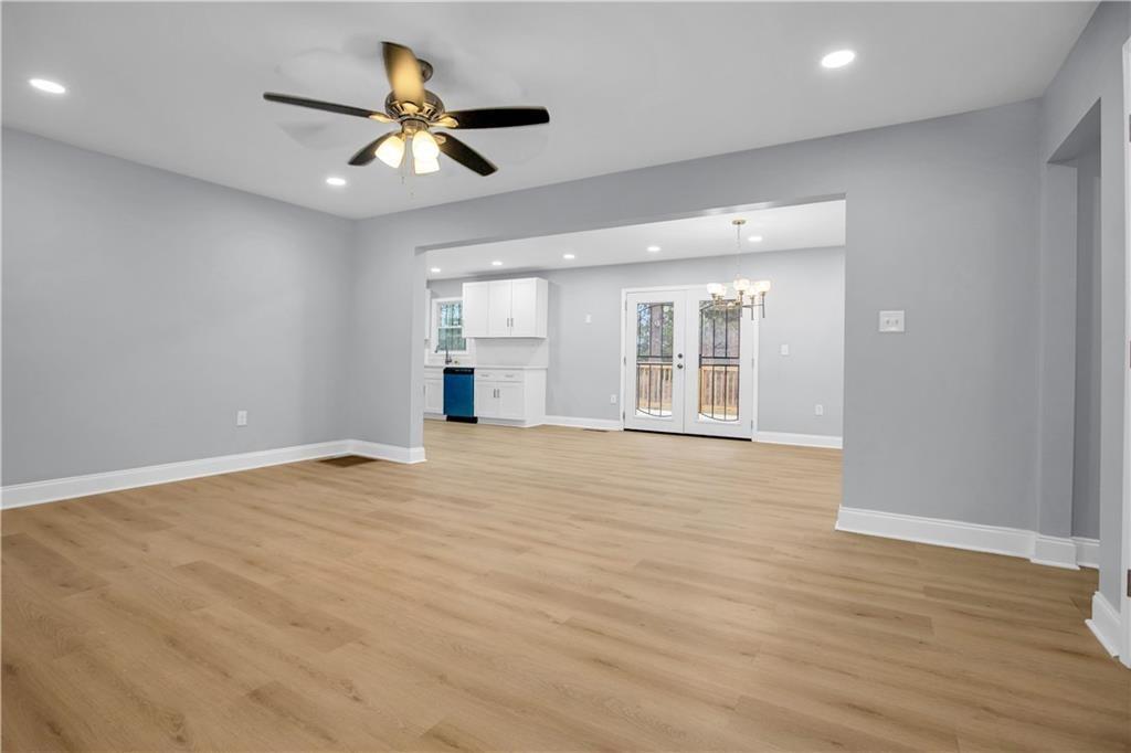 2000 Fairburn Road Southwest Atlanta, GA 30331 - Photo 8 of 24 a view of an empty room with wooden floor and a ceiling fan