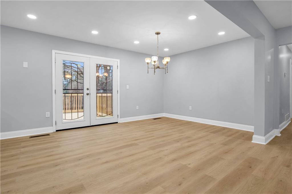 2000 Fairburn Road Southwest Atlanta, GA 30331 - Photo 10 of 24 a view of an empty room with wooden floor and a window