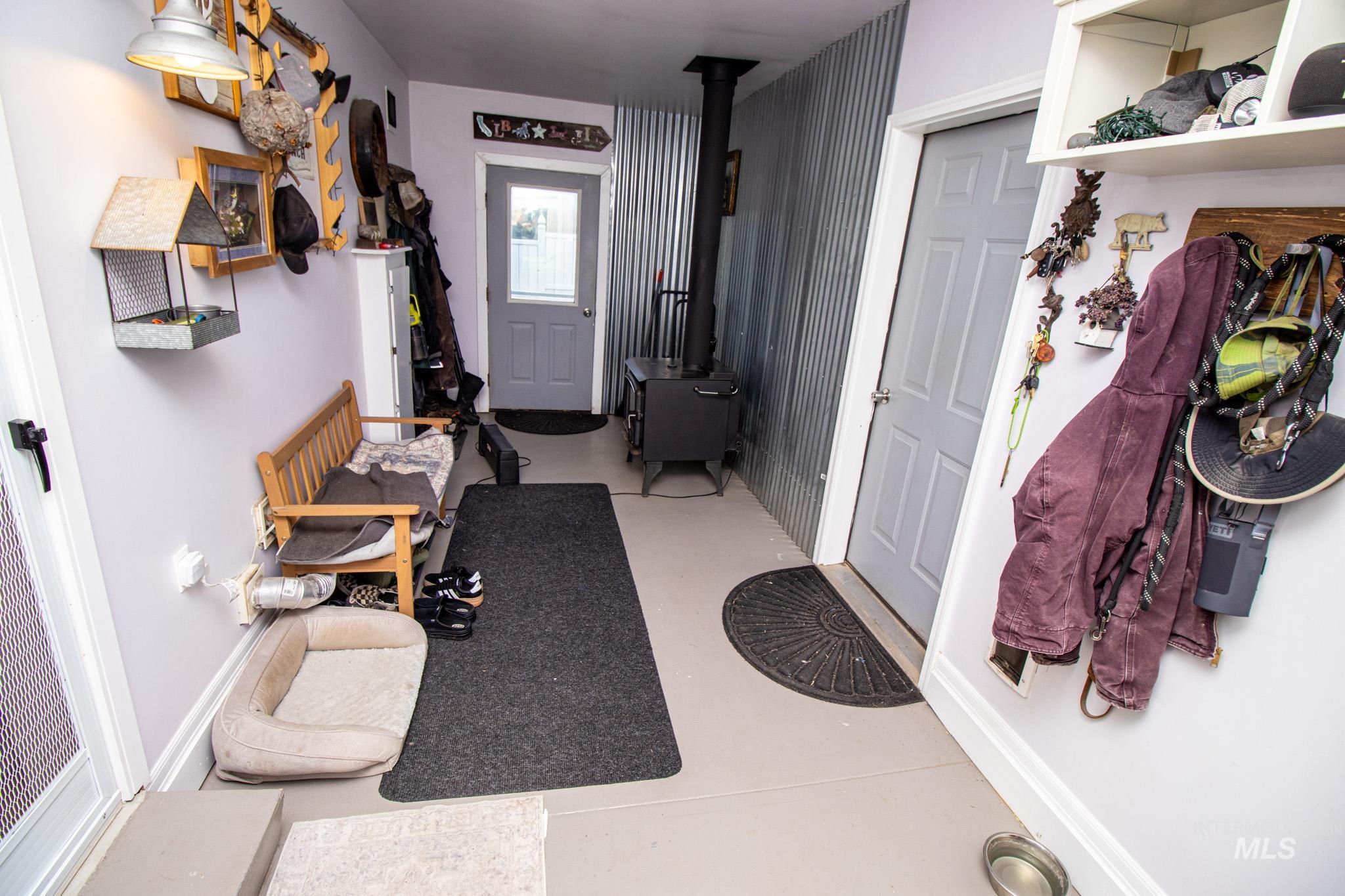 5404 Freeman Creek Road Lenore, ID 83541 - Photo 13 of 50 Mudroom featuring finished concrete floors and a wood stove